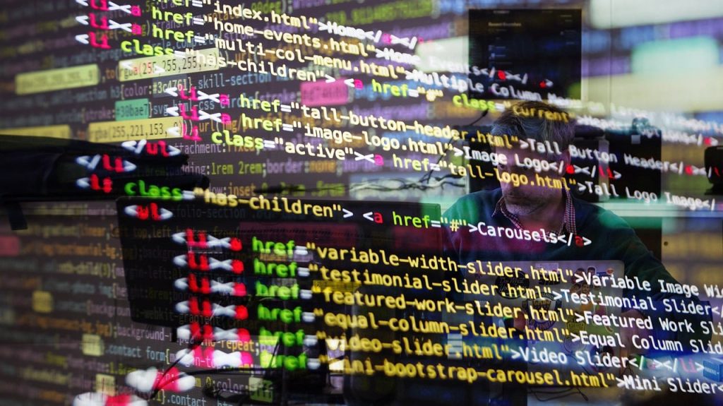HTML code overlaid on a developer working at a computer