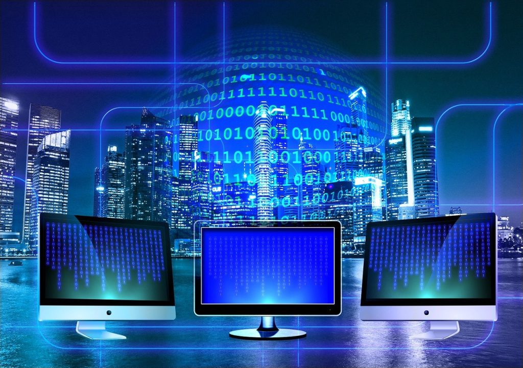 Illustration of three monitors showing binary code against a night city skyline